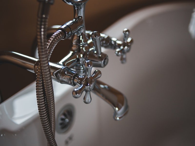 Silver faucet on a clean sink