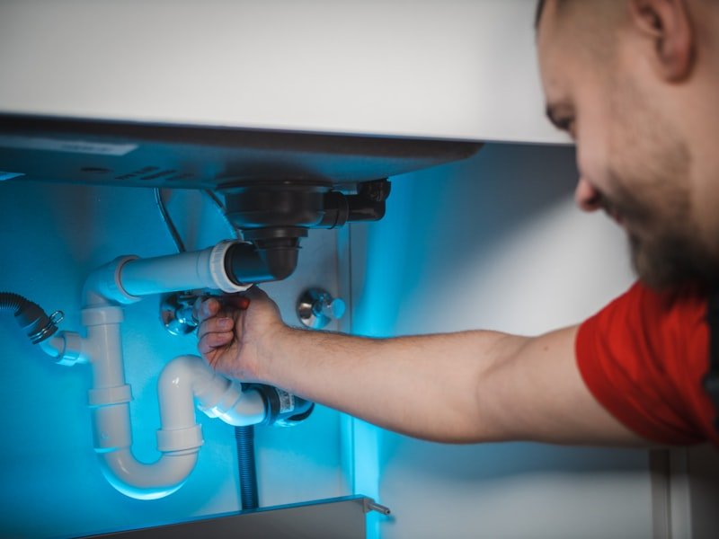 Plumber repairing a residential water pipe